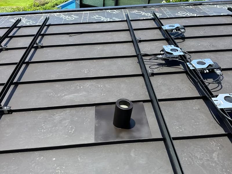 Metal roof mounting rail installation on a commercial roof